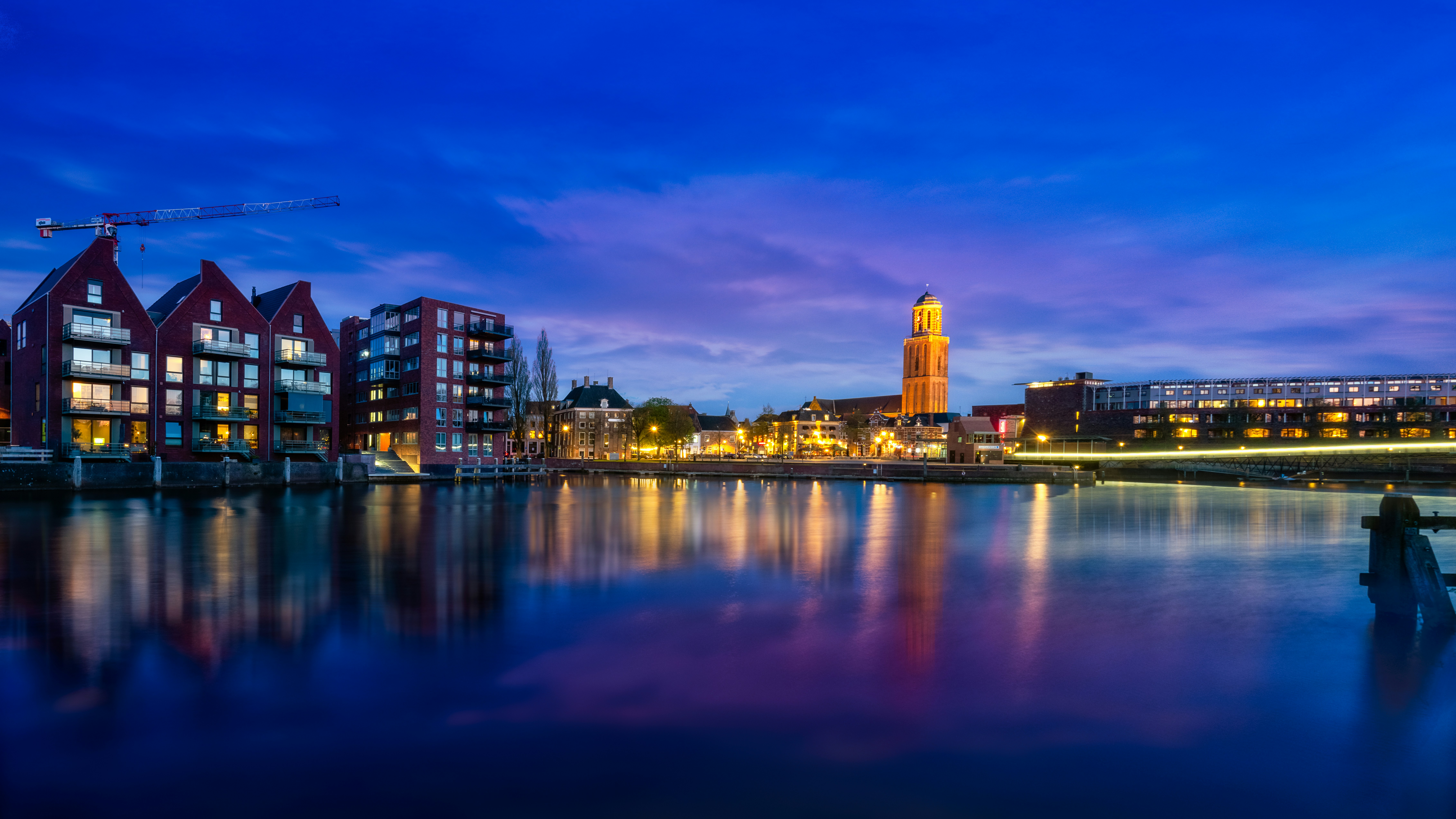 Zwolle skyline at twilight with the Peperbus tower glowing against a violet sky.